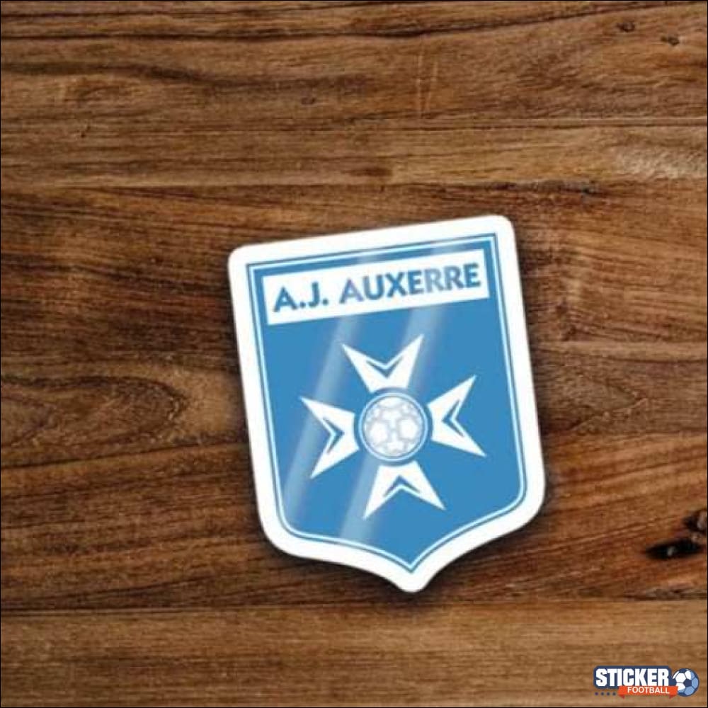 Un autocollant bleu et blanc en forme de bouclier avec un ballon de football.