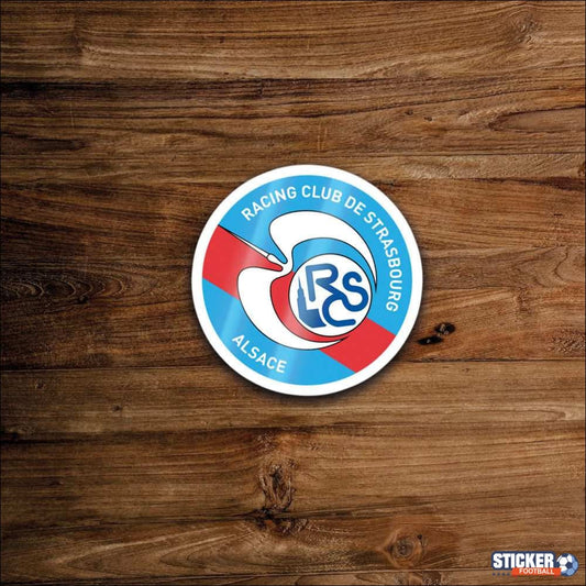 Autocollant rond avec un motif bleu, blanc et rouge.